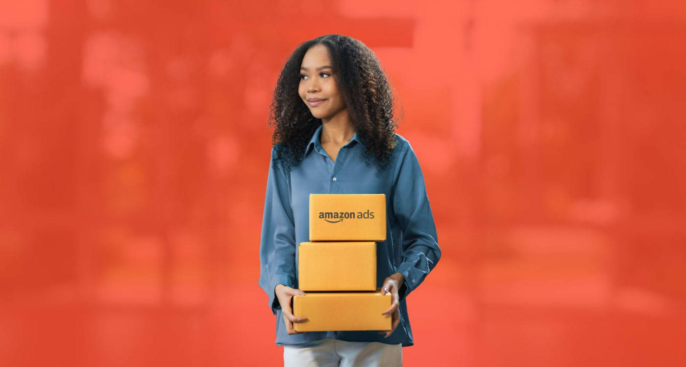 Woman holding Amazon Ads packages in front of an orange background, representing Amazon advertising solutions.