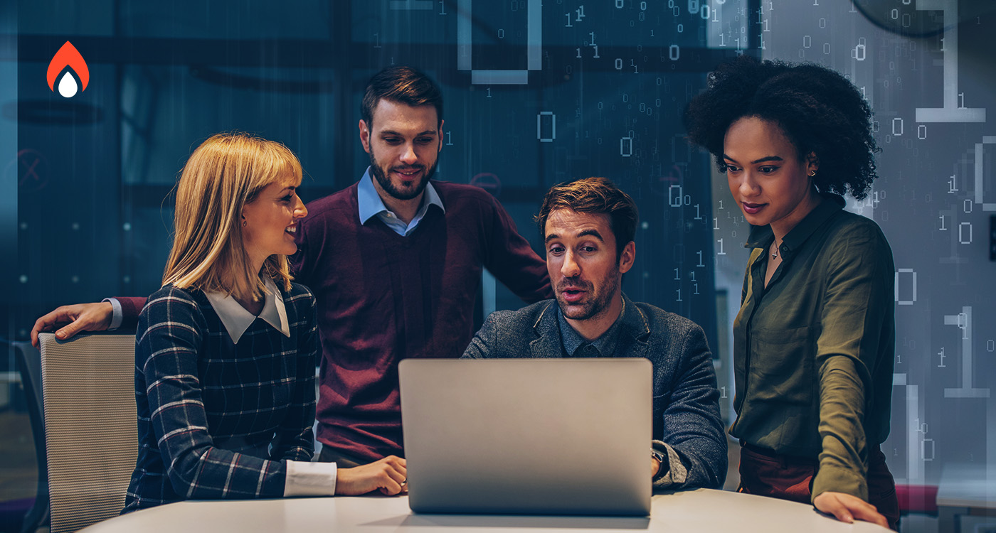 Marketing professionals collaborating around a laptop while reviewing 2026 digital marketing insights.